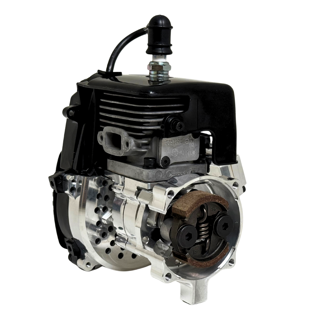 Close front view of the HPRC 34cc race ported Zenoah engine showing the raw silver billet clutch bell, cylinder fins and reed case mounting plate