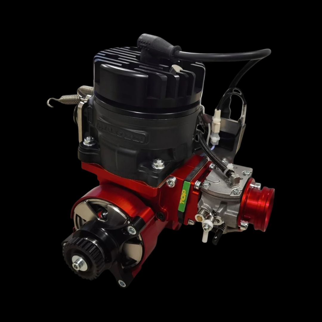 Engine block with red and black components on a black background