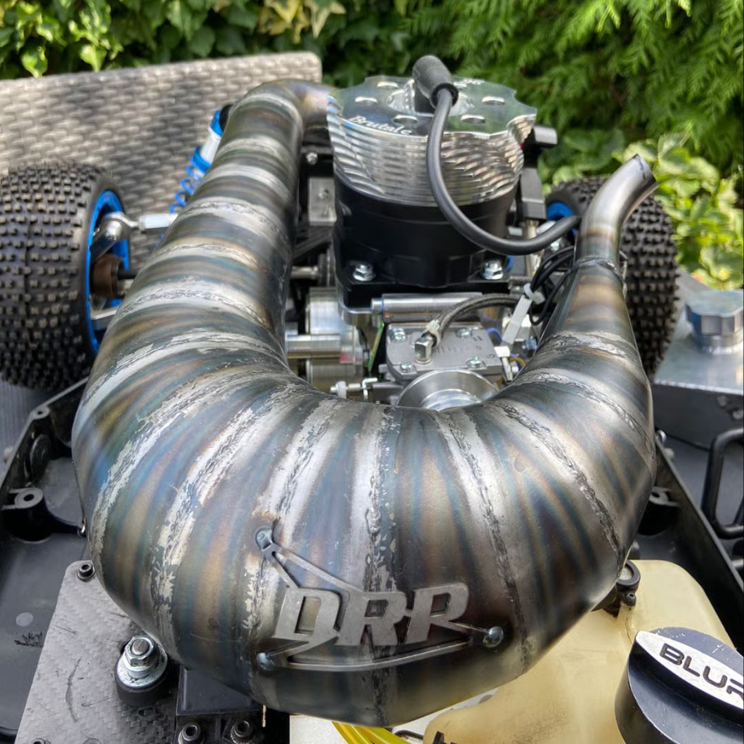 Close-up of a high-performance engine with visible DRP branding, set against a natural background.