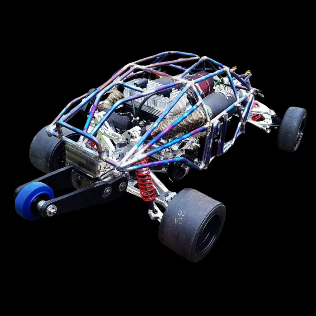 Close-up of a model car chassis with visible components on a black background