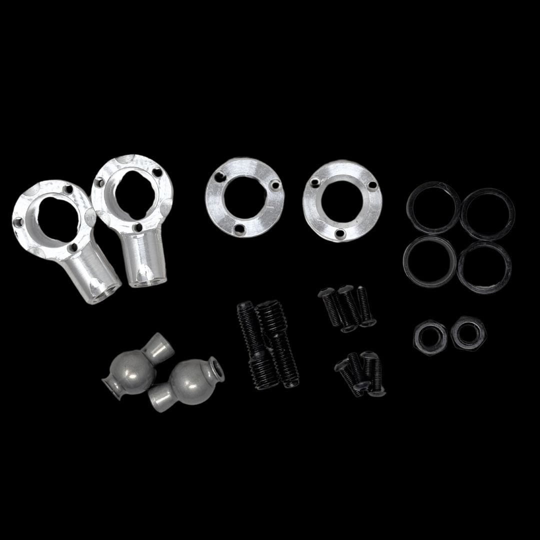 A set of metal and nylon parts for a remote control car, including shafts, bushings, and other suspension components.
