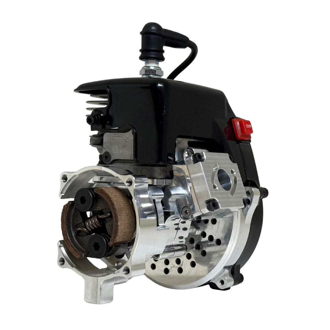 Front view of the HPRC 32cc race ported Zenoah engine highlighting the raw silver clutch assembly, reed case and vented billet bell housing