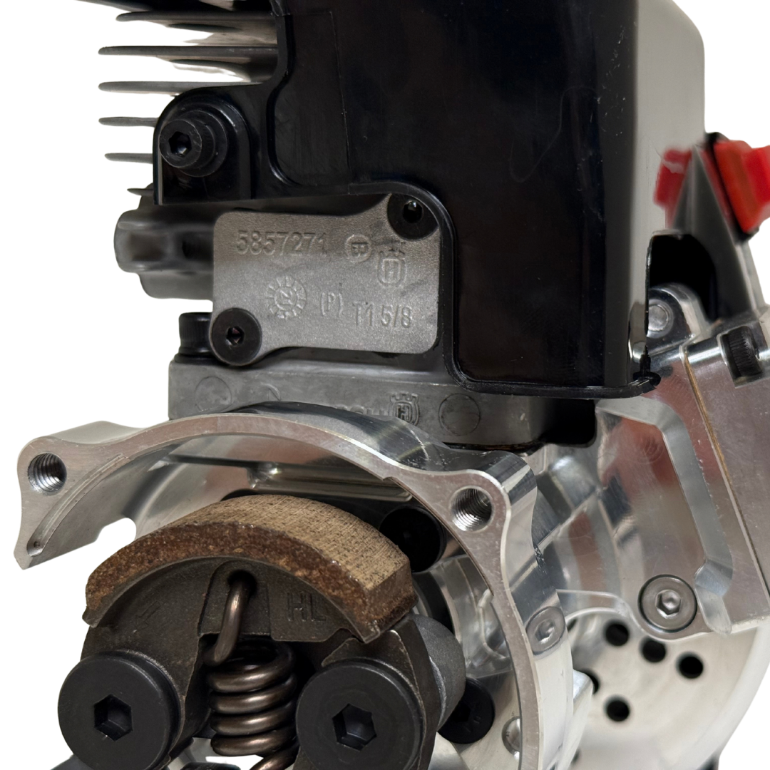 Close-up of the HPRC 34cc race ported Zenoah engine's raw silver clutch mechanism, showing the clutch shoe, spring and mounting hardware in detail