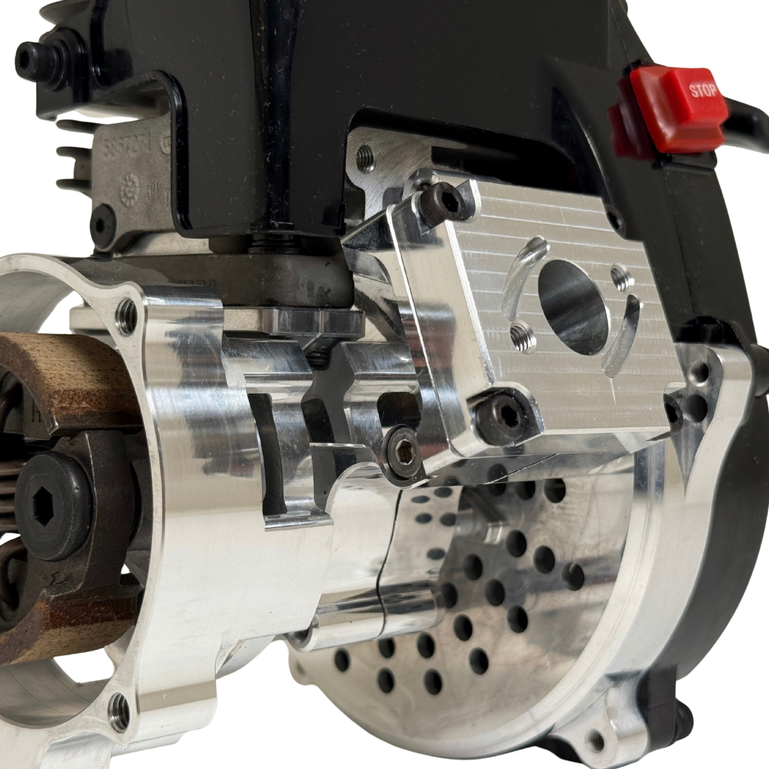 Close-up of the HPRC 38cc race ported Fujiwara engine's raw silver clutch mechanism, showing the clutch shoe, spring and billet mounting plate