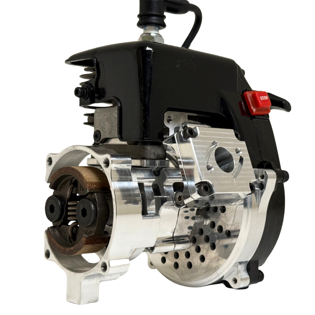 Close side view of the HPRC 38cc race ported Fujiwara engine showing the raw silver billet reed case, clutch bell and cylinder fins in detail