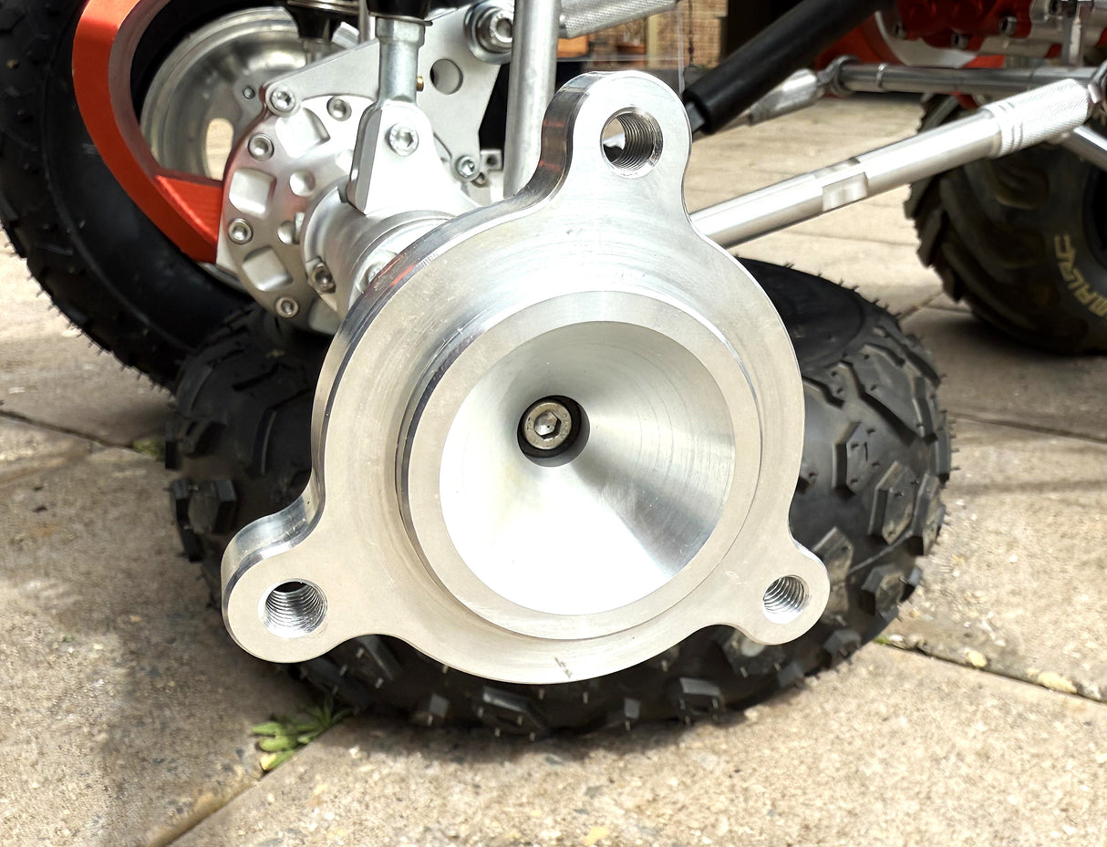 Close-up of a motorcycle wheel with a metallic hub on a concrete surface