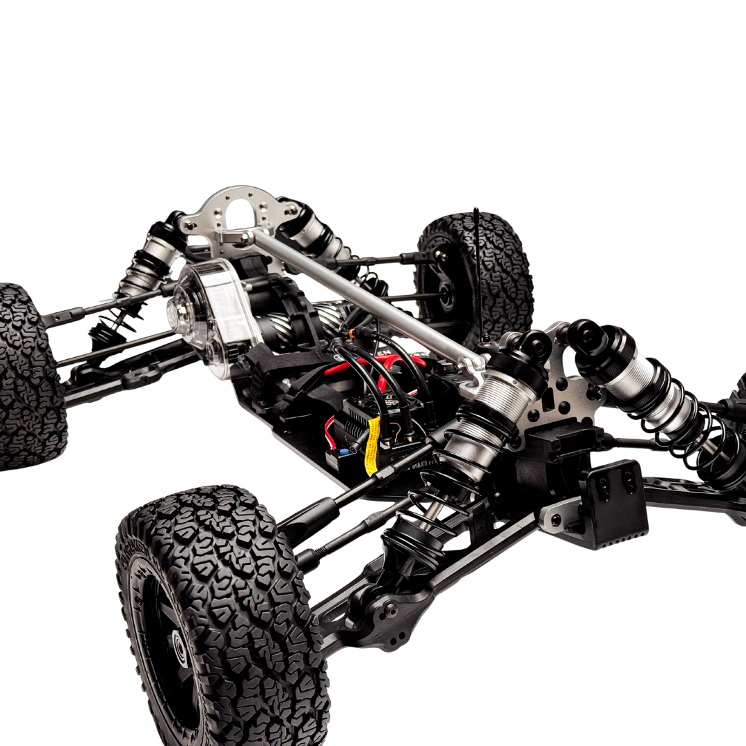 Close-up of a mechanical vehicle chassis with visible suspension and tires on a white background