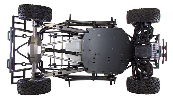 Close-up of a black off-road vehicle chassis with suspension and tires on a white background