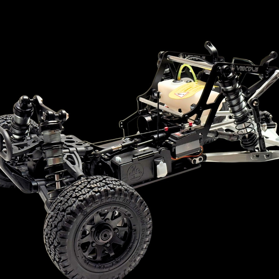Close-up of a detailed model car chassis with visible components on a black background