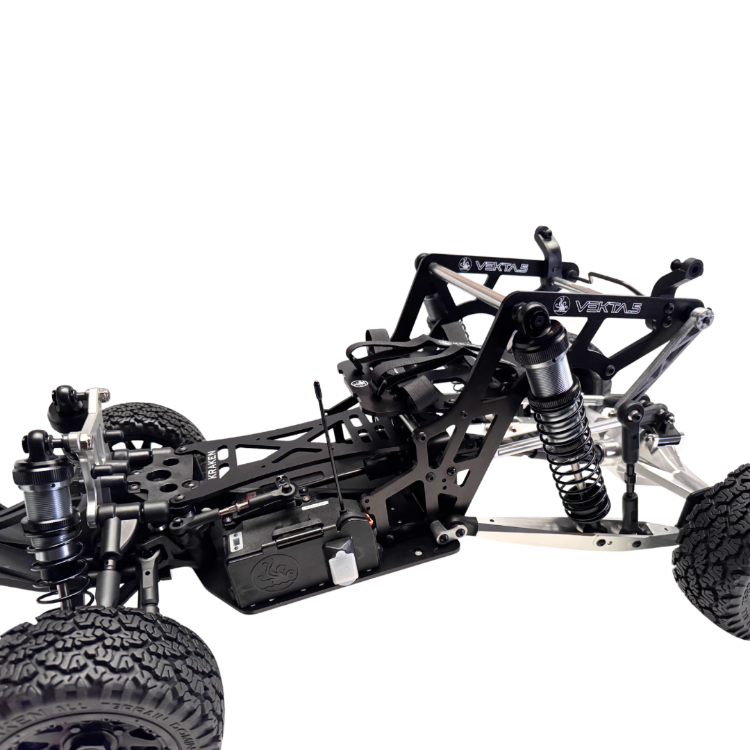 Close-up of a black and silver RC car chassis on a white background
