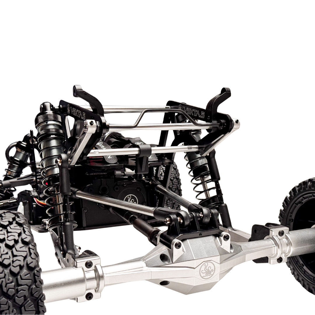 Close-up of a detailed metal chassis with suspension components on a white background