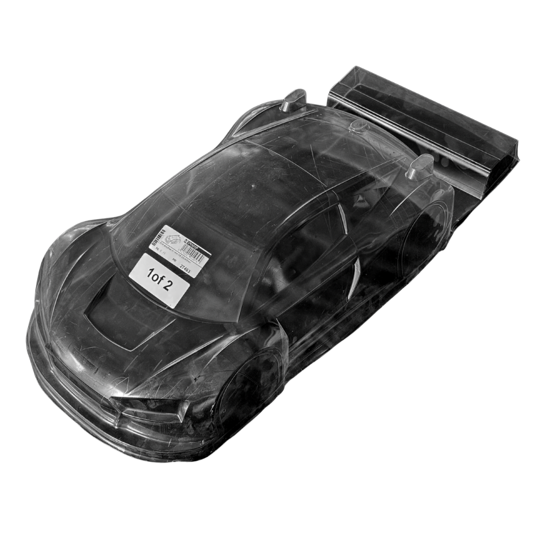 Clear plastic model car with a label on a white background