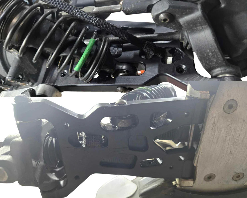 A set of black machined front arms for a remote control vehicle, showing detailed machining and fitment, installed on a vehicle.