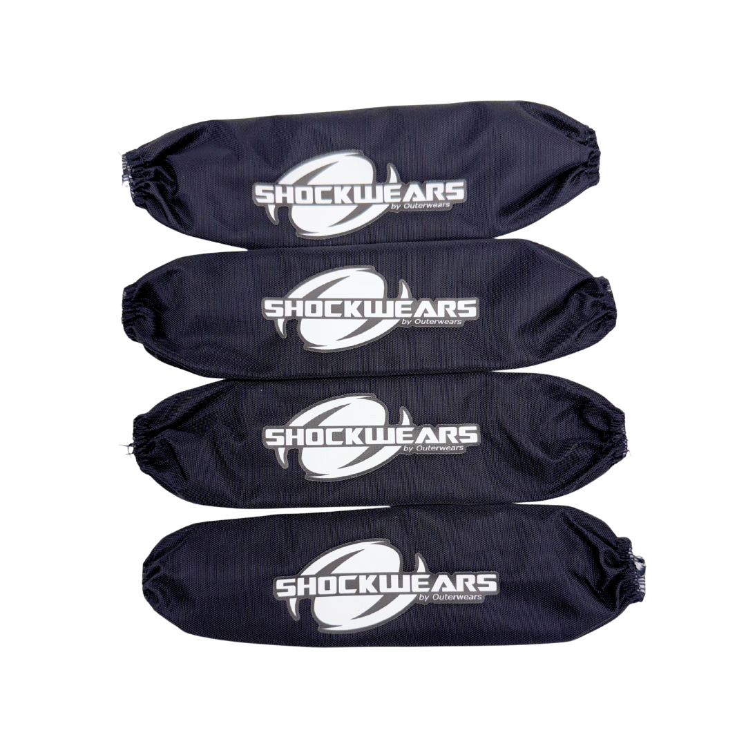 Four black shock absorber covers with 'SHOCKWEARS' logo on a white background