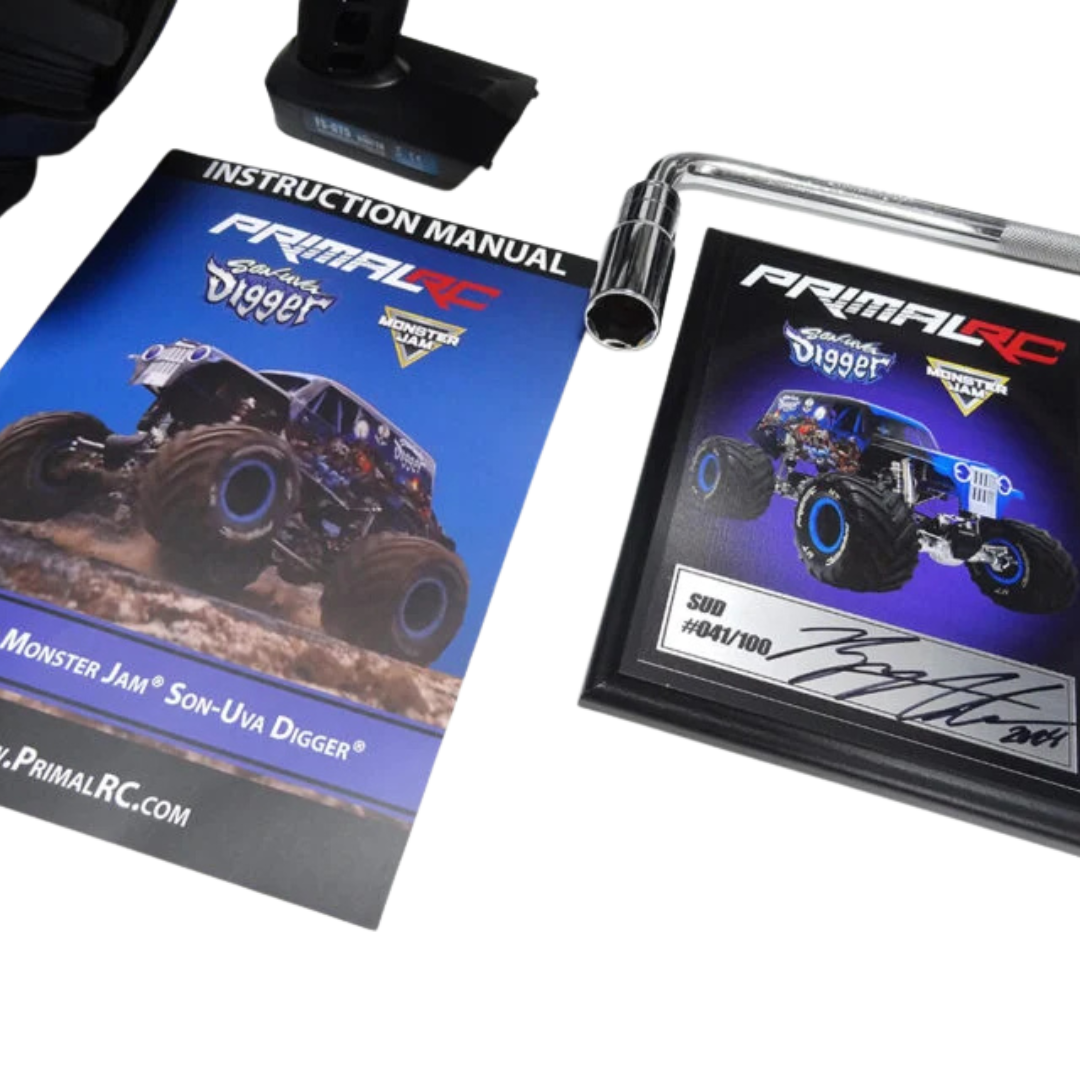 Primal RC Monster Jam Son-Uva Digger model with instruction manual and display stand on a white background