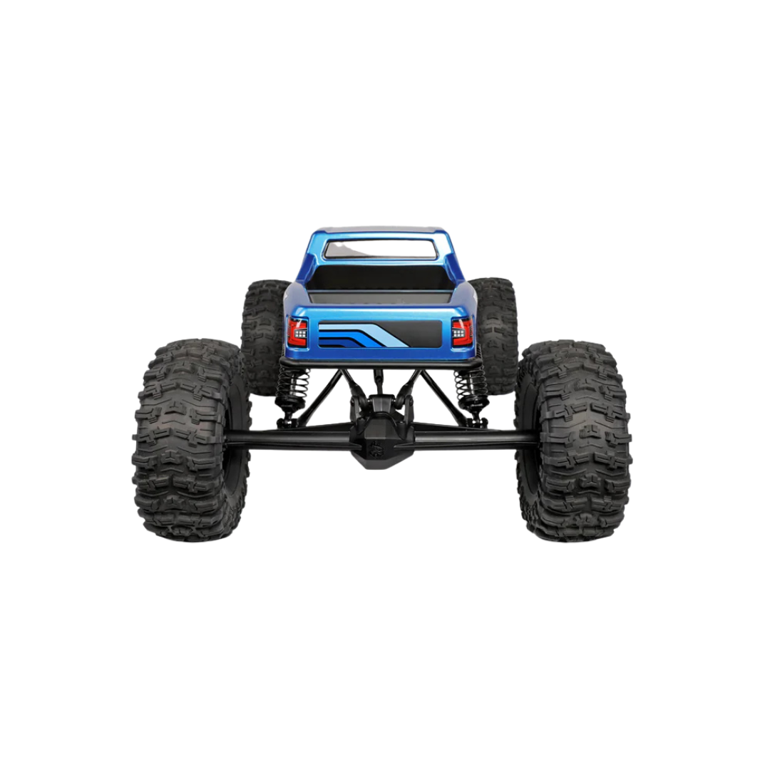 Blue monster truck with large black tires on a white background