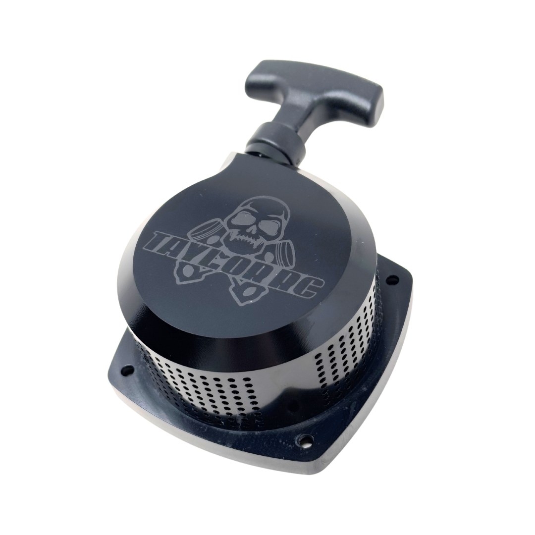 Black metal component with skull design on a white background