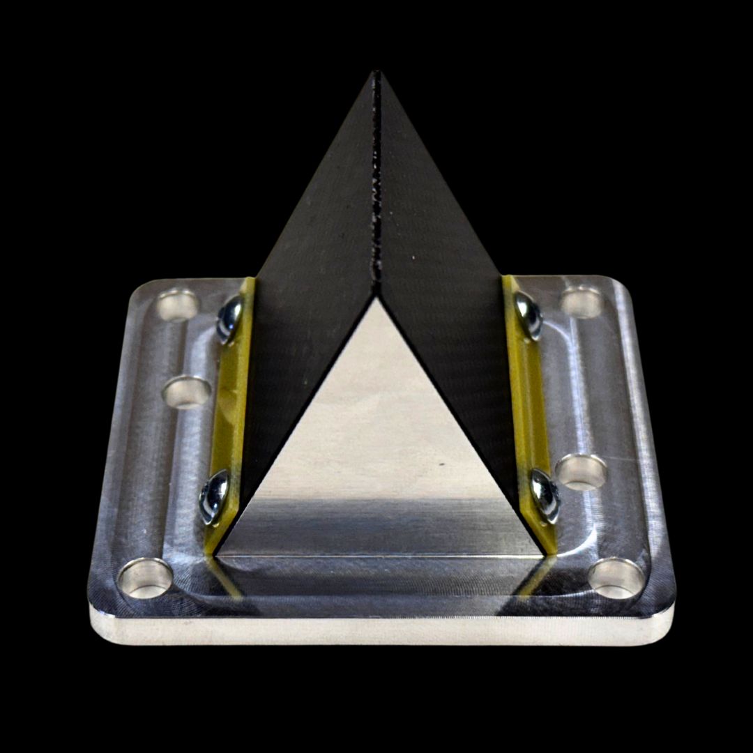 Triangular reed valve with black, yellow, and silver colors on a black background