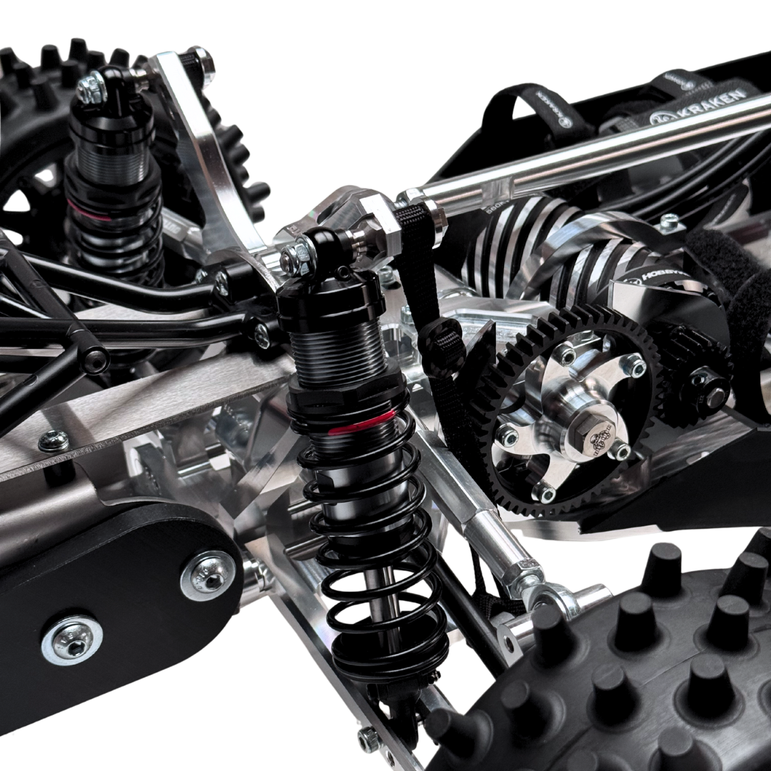 Close-up of a detailed metal chassis with suspension components on a white background