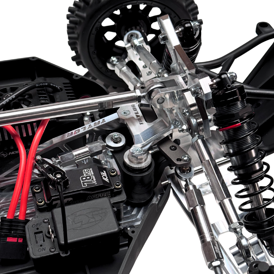 Close-up of a detailed model vehicle chassis with suspension and electronic components.