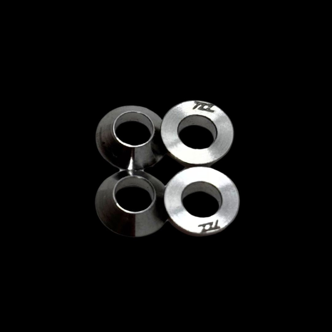 titanium silver conical washers on a black background