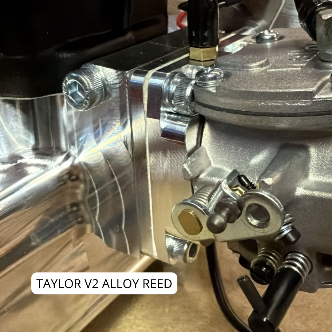 Close-up of a Taylor V2 Alloy Reed engine component on a wooden surface.