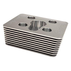 Metallic block with circular holes on a white background