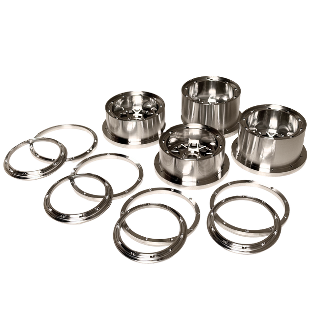 Beast RC Baja 5B complete billet wheel set with 8-piece beadlocks, angled view showing the narrower front wheels with hidden-bolt beadlock rings