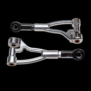 Two metallic control arms on a black background