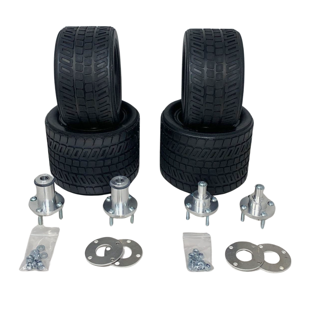 Set of four black tires and multiple metal components on a white background