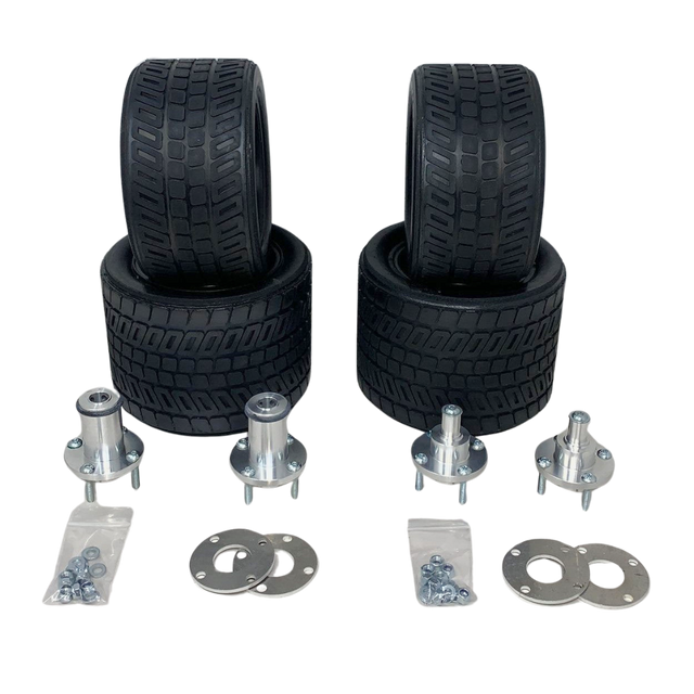 Set of four black tires and multiple metal components on a white background