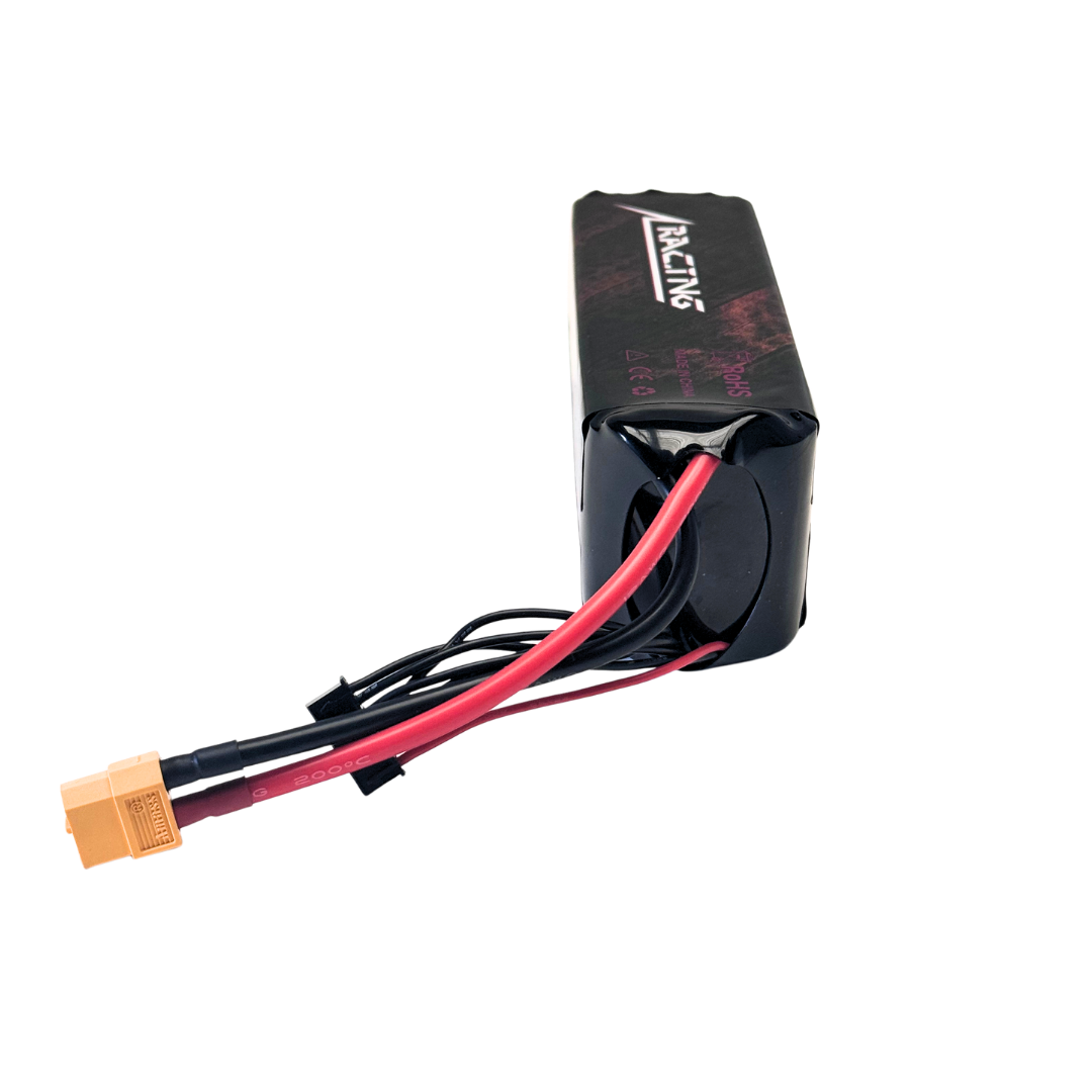 Black battery pack with red and black cables on a white background