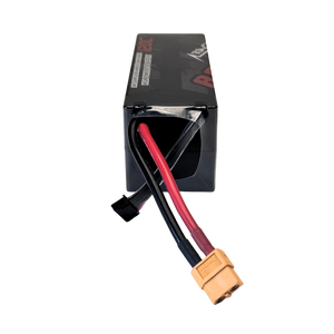 Black battery pack with red and black cables and a yellow connector on a white background