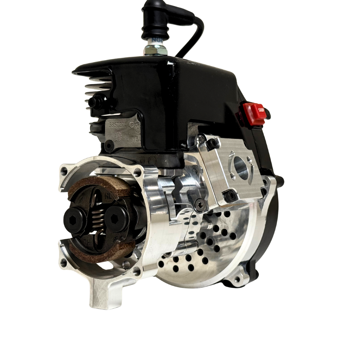 Front view of the HPRC 34cc race ported Zenoah engine showing the raw silver billet clutch bell with exposed clutch shoes, spring and cooling vent holes
