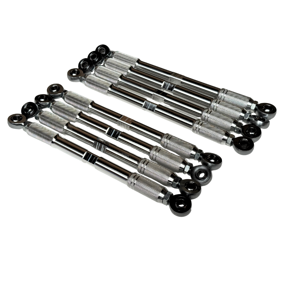 Eight automotive tie rod ends with knurled silver metal centers and black spherical caps, arranged in two parallel rows on a plain white background.