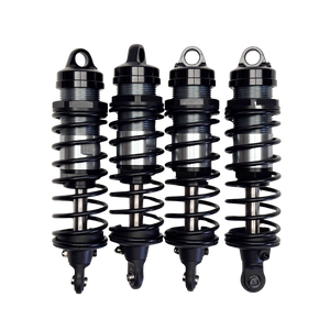 Four black shock absorbers on a white background