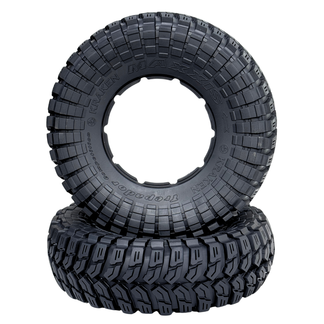 Two black off-road tires with tread pattern on a white background