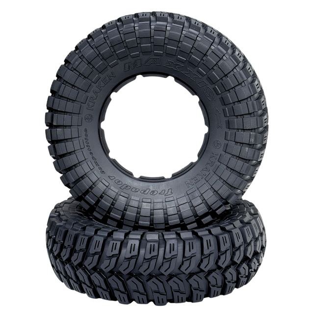 Two black off-road tires with tread pattern on a white background