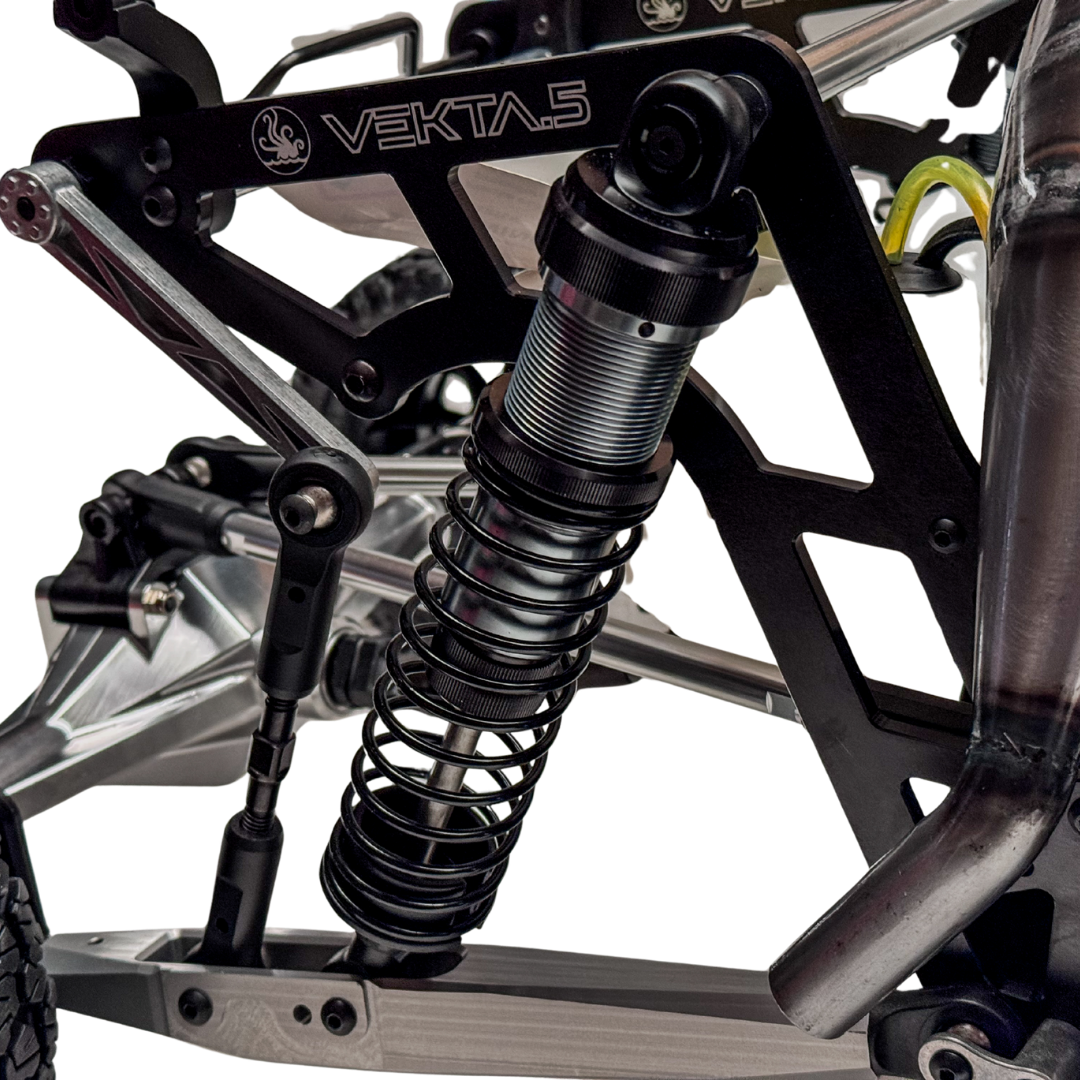 Close-up of a suspension system on a vehicle with 'VEKTA' branding.