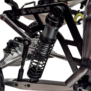 Close-up of a suspension system on a vehicle with 'VEKTA' branding.