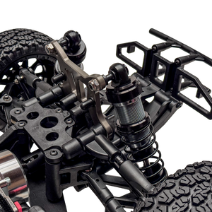 Close-up of a detailed model vehicle chassis with suspension and wheel setup on a white background
