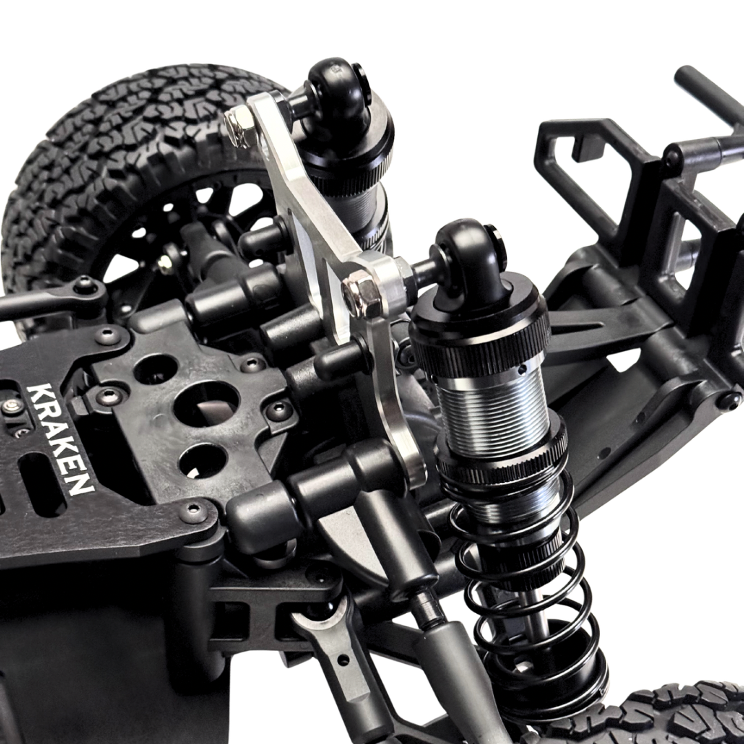 Close-up of a Kraken RC car chassis with suspension and wheel setup on a white background
