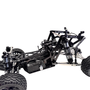 Close-up of a black and silver RC car chassis on a white background