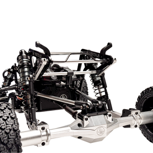 Close-up of a detailed metal chassis with suspension components on a white background