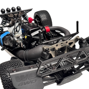 Close-up of a detailed model car chassis with visible branding on a white background