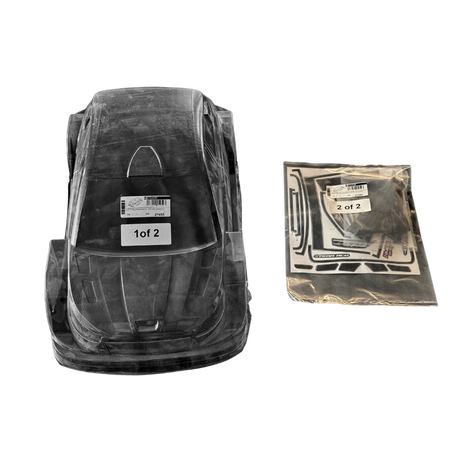 Black plastic car seat base with clear cover and additional packaging on a white background