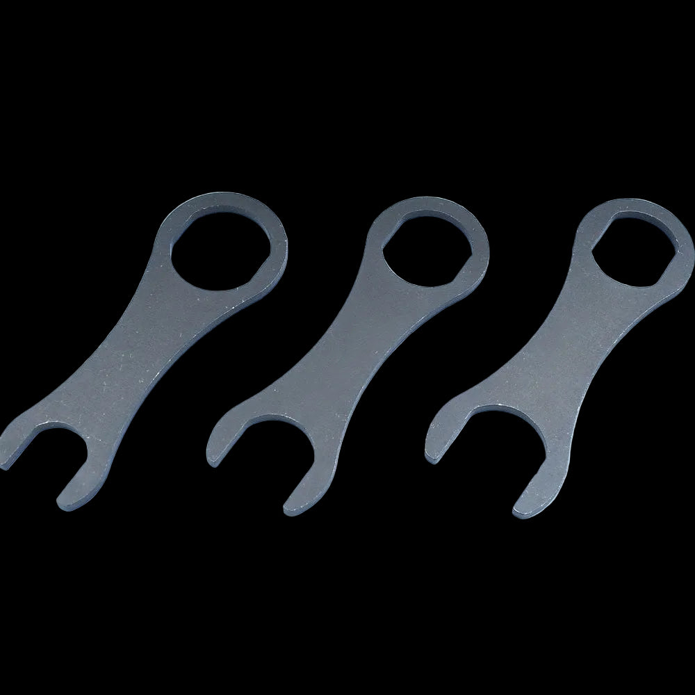 Three metallic spanners on a light blue background