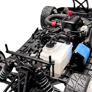 Close-up of a detailed model car chassis with various components on a white background