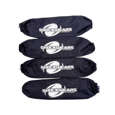 Four black shock absorber covers with 'SHOCKWEARS' logo on a white background