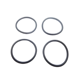 Four black rubber o-rings on a white background